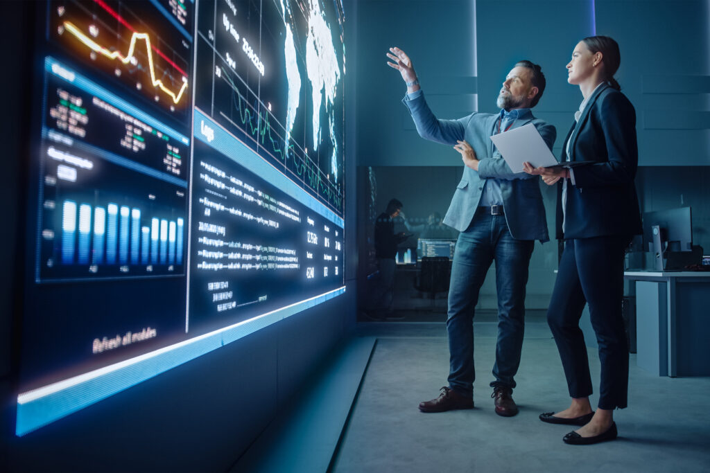 MASSIVE SOFTWARE LLC for Risk & Compliance Teams , two teammates looking at a giant screen
