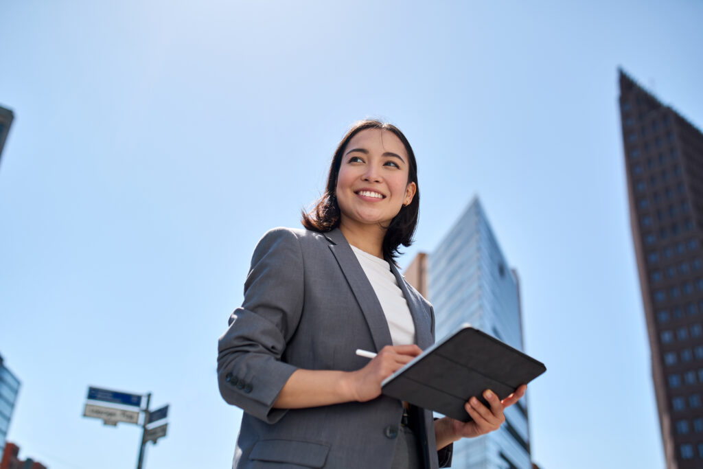 MASSIVE SOFTWARE LLC for Tech & Innovation teams. Woman with a tablet with city in the background